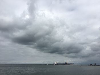 Scenic view of sea against storm clouds