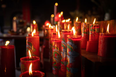 Illuminated candles burning in temple