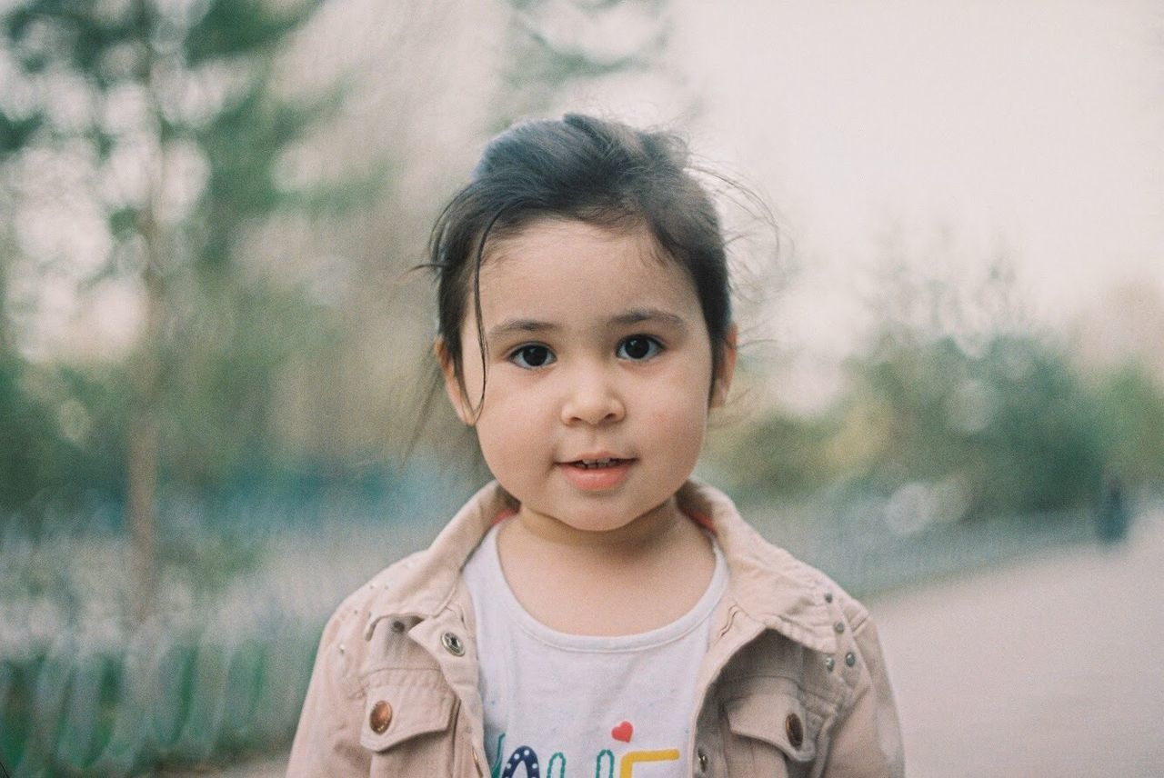 portrait, childhood, child, headshot, cute, front view, one person, real people, focus on foreground, looking at camera, females, innocence, casual clothing, girls, lifestyles, women, leisure activity, outdoors, hairstyle, human face