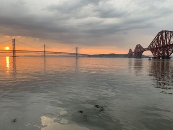 View of bridge over river against cloudy sky