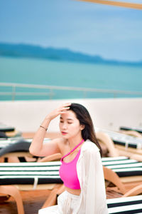 Portrait of young woman sitting on boat