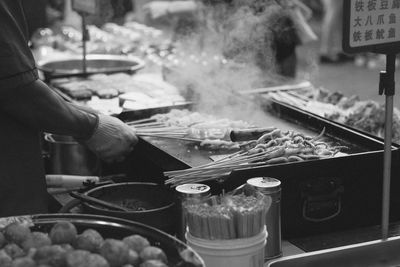 Cropped hand of man preparing food at market