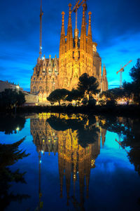 Reflection of building in lake at night