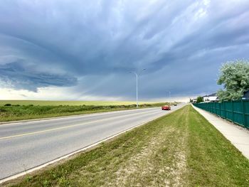 Vehicles on road against sky