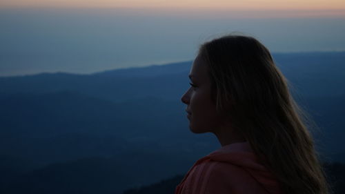 Close-up of young woman looking at landscape