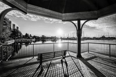 The sun shines during morning into the wooden pergola located on the humber bay waterfront