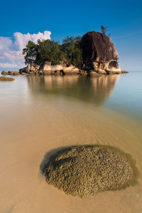 View of rocks on beach against sky