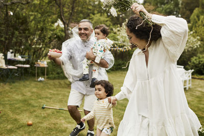 Happy parents and children in garden