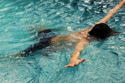 High angle view of woman swimming in pool