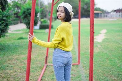 Side view of a young woman standing outdoors