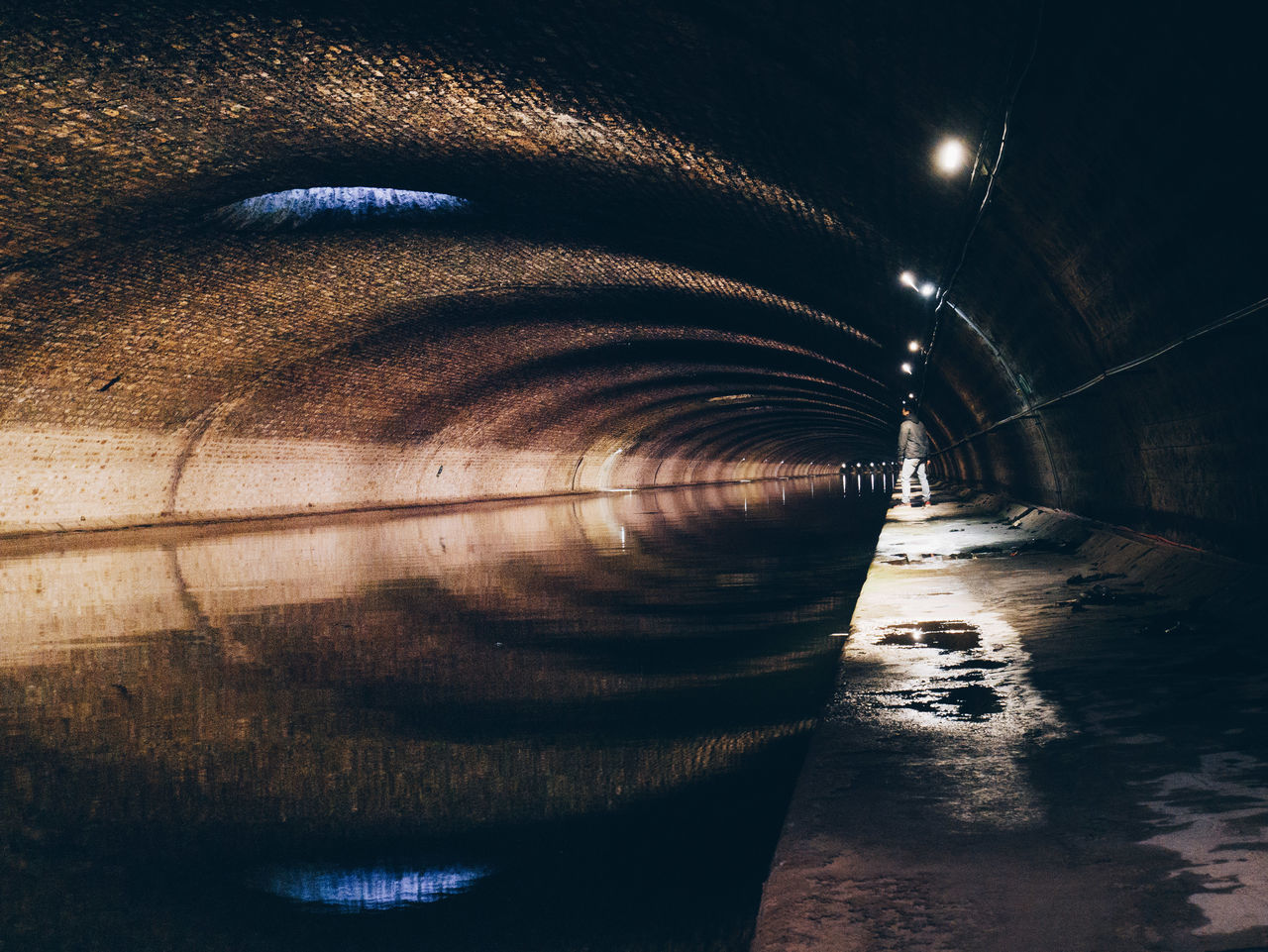 CLOSE-UP OF ILLUMINATED LIGHTS IN TUNNEL