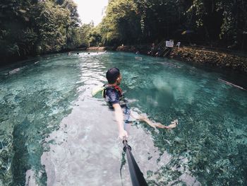 Man holding monopod in lake