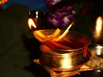 Close-up of lit candles on table