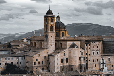 Buildings against sky with mountain in background