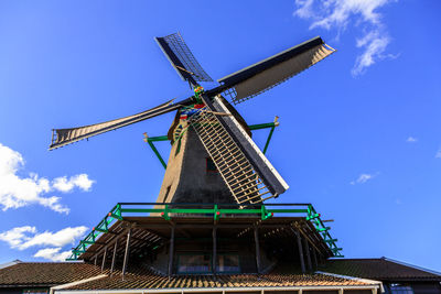 Low angle view of traditional windmill against sky