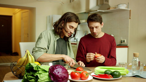 Young couple preparing food in kitchen at home