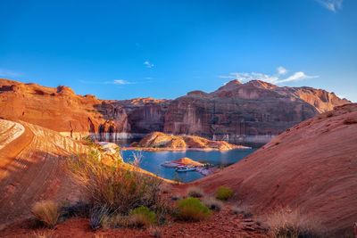 Scenic view of rock formations against blue sky