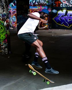 Side view of man skateboarding on skateboard