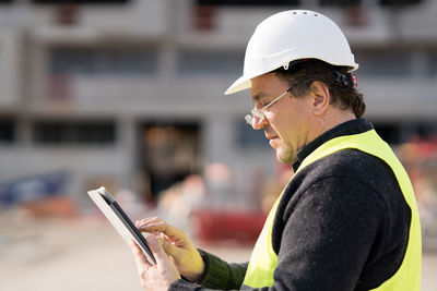 Worker using phone at construction site