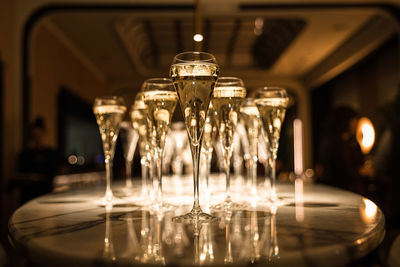 Set of champagne glasses on table top golden light bubbly fine wining in a restaurant