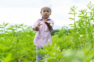 Smiling boy standing on field