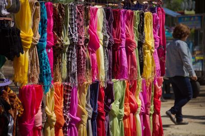 Various clothes hanging in store for sale at market