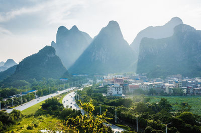 Townscape by mountains against sky