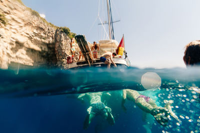 Close-up of man in sea against clear sky