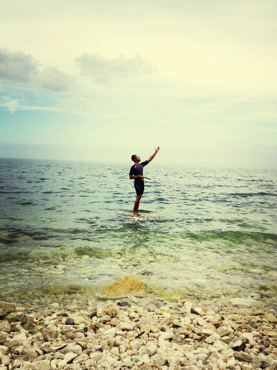 water, full length, sea, lifestyles, leisure activity, horizon over water, sky, tranquil scene, scenics, standing, tranquility, rear view, beauty in nature, beach, nature, shore, vacations, idyllic