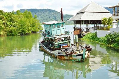 Boats in river with buildings in background