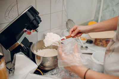 Woman filling cream in piping bag