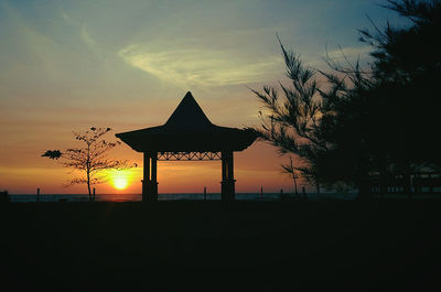 Silhouette built structure against sky during sunset