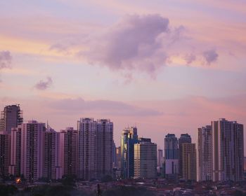 Skyscrapers in city at dusk