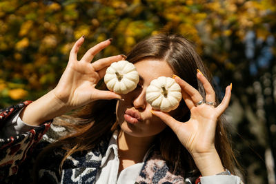 Close-up of woman holding plant