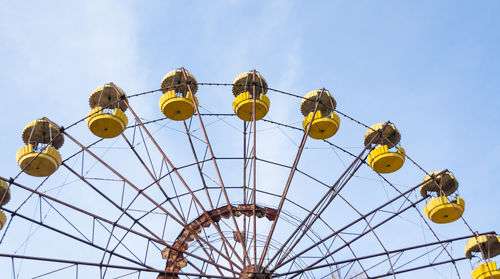 Low angle view of ferris wheel against sky