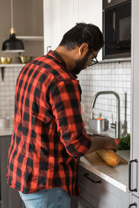 Side view of man working in kitchen