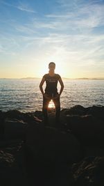 Rear view of woman standing on beach