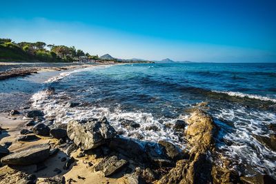 Scenic view of sea against clear blue sky