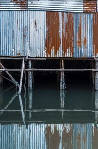 Close-up of old rusty metallic structure in water