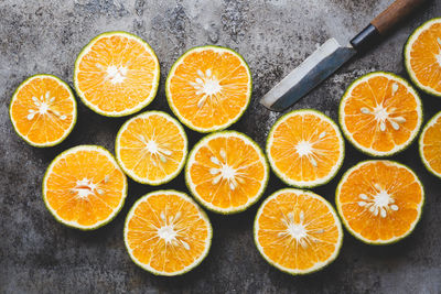 Close-up of orange fruits and knife on table