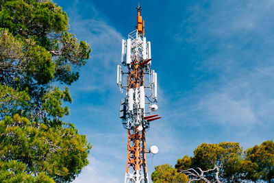 Low angle view of communications tower against sky