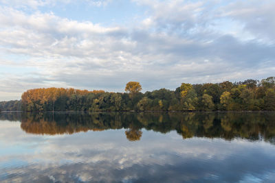 Reflection of trees in lake against sky