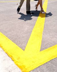 Low section of people walking on road