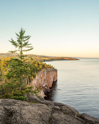 Scenic view of sea against clear sky during sunset