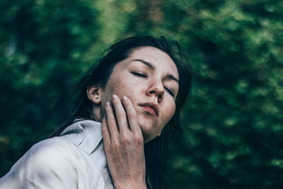 Portrait of young woman with eyes closed