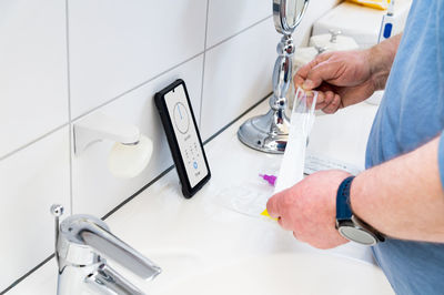 High angle view of man working in bathroom