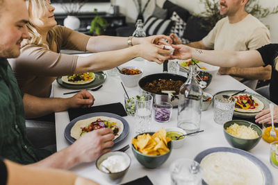 Group of friends eating mexican food at home