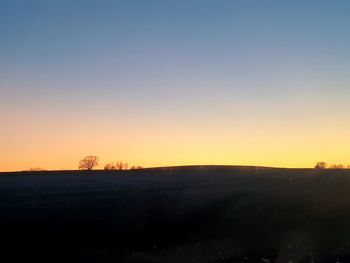 Scenic view of silhouette landscape against clear sky during sunset