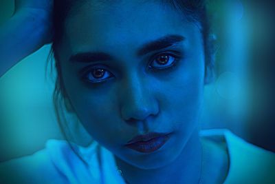 Close-up portrait of a serious young woman