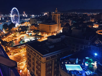 High angle view of illuminated buildings in city at night